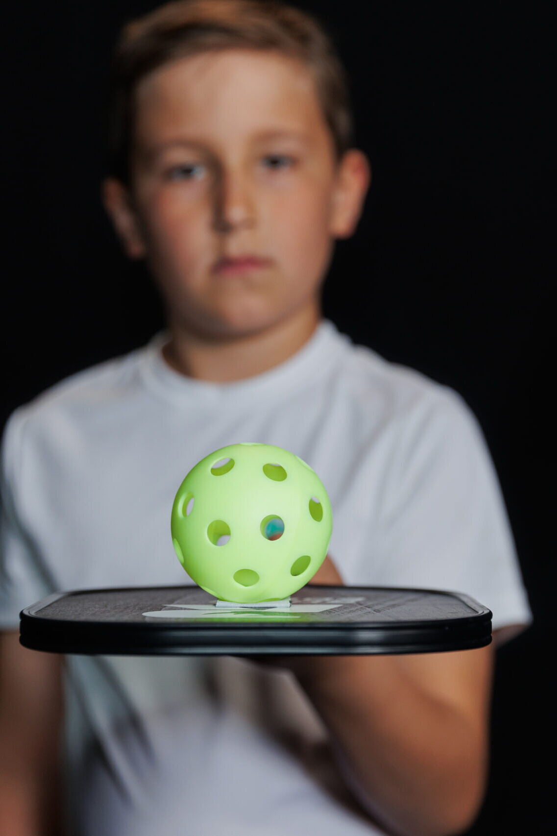 Fortis Sports Boy Holding Pickleball on Paddle