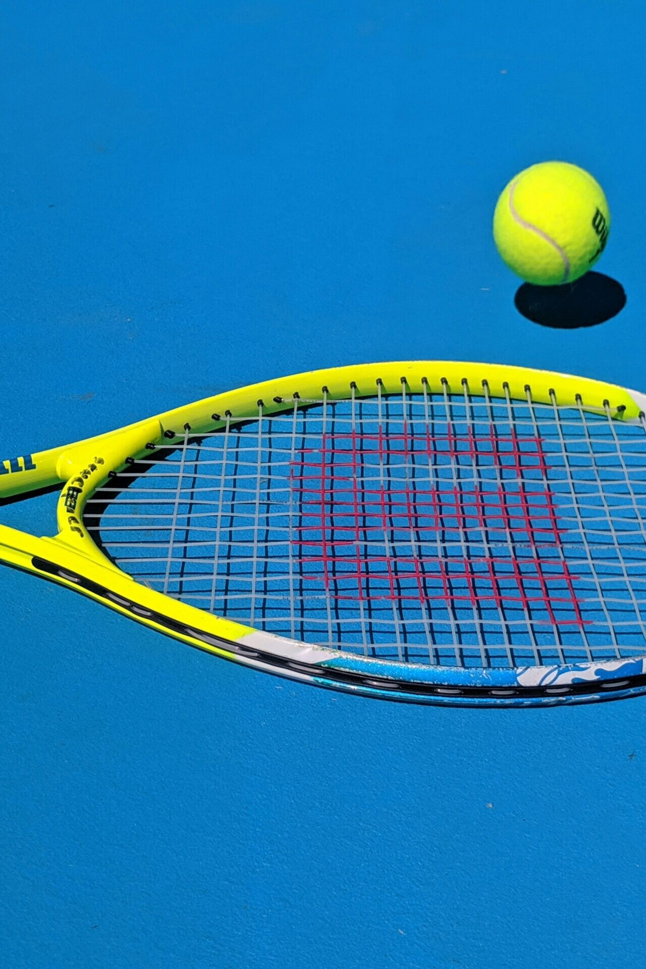 Fortis Sports Tennis Racquet and Ball on Court